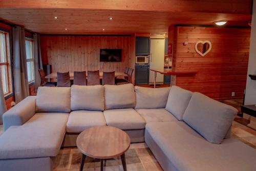 a living room with a large couch and a table at Bakkebyvegen 7A in Trysil