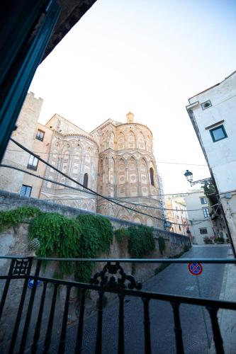 a large building in front of a building at Duomo View Apartment in Monreale