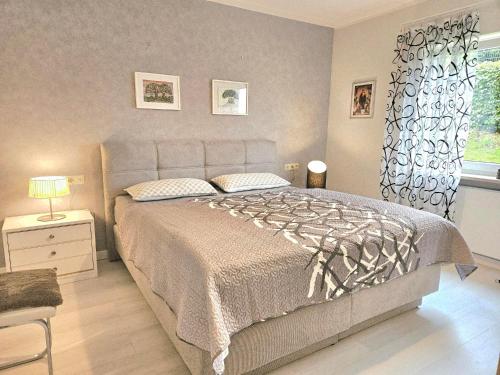 a bedroom with a large bed and a window at Ferienwohnung Arquitecto Talblick mit Balkon - Mein SWH in Todtmoos