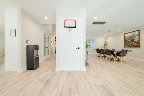 an empty room with a basketball hoop on the door at Luxury 6BR House with Pool & Outdoor BBQ in Plainview