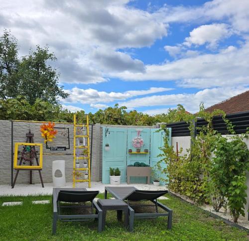 a patio with two chairs and a table in a yard at BTP House in Hunedoara