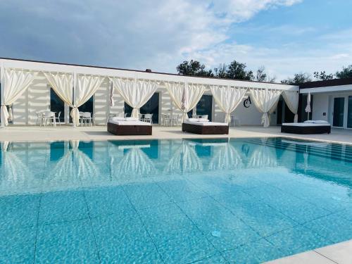a swimming pool in front of a building at Agricola Chiani in Melendugno