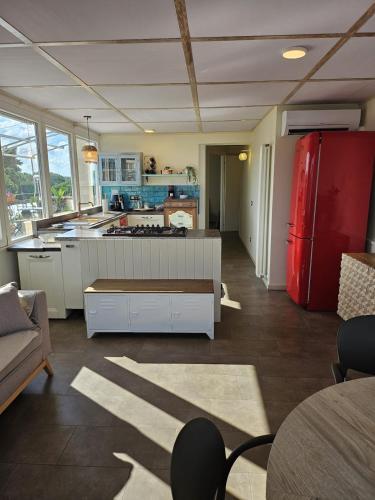 a kitchen with a red refrigerator in a room at La Terrazza in Rome