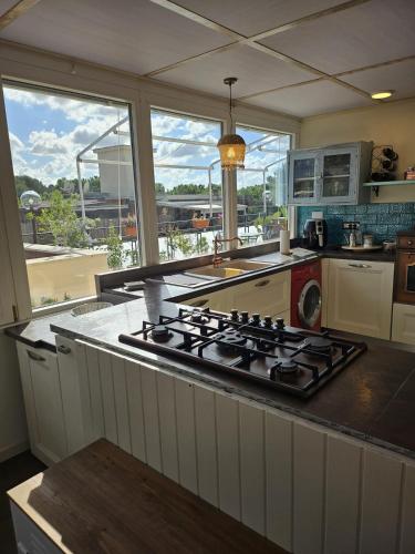 a kitchen with a stove top in front of a window at La Terrazza in Rome