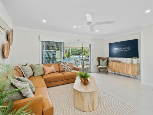 a living room with a couch and a table at The Chill House - Heated Pool - Entertainment Area in Gold Coast