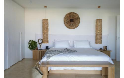 a bedroom with a bed and a mirror on the wall at Blanc de Blanc in Yzerfontein