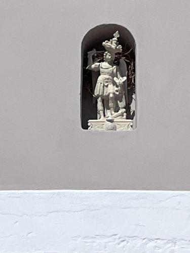 a statue of a woman sitting on a window at Ripa di sassi in Manfredonia