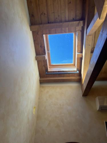 a window in a room with a wooden ceiling at Ripa di sassi in Manfredonia