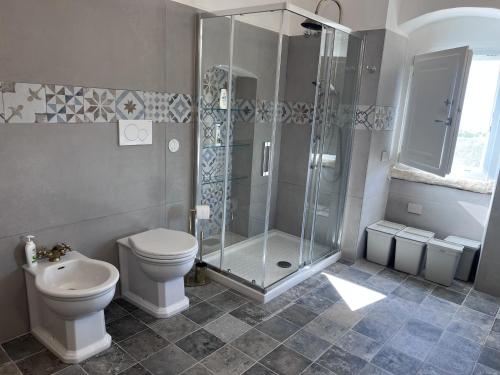 a bathroom with a shower and a toilet and a sink at Ripa di sassi in Manfredonia