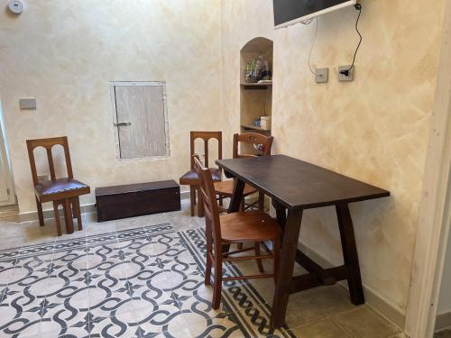 a dining room with a wooden table and chairs at Ripa di sassi in Manfredonia