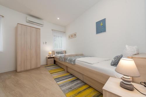 a bedroom with two beds and a closet at Unique luxury Villa Feriatum Lissa in Ždrelac