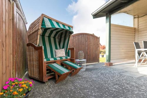 a wicker chair sitting on a patio at Kleines Schweden in Hennstedt