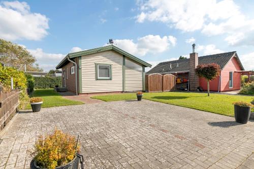 a home with a brick driveway in front of a house at Kleines Schweden in Hennstedt