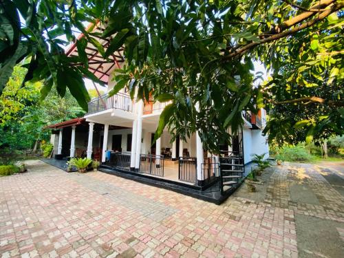 a house with a brick driveway in front of it at Ritigala Hideaway in Kekirawa