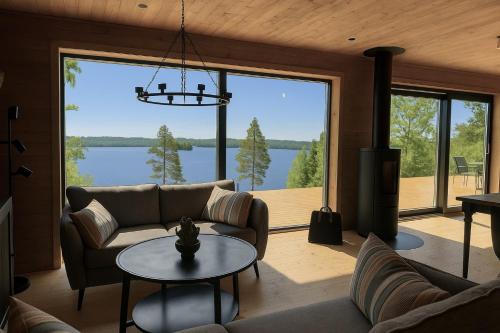 a living room with a couch and a table at Holiday home with sauna and lake view in scenic Lonashult in Finnanäs