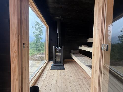an open door to a room with a woodburning stove at Holiday home with sauna and lake view in scenic Lonashult in Finnanäs