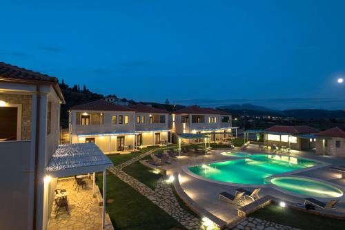 a villa with a swimming pool at night at Imathoessa in Gialova
