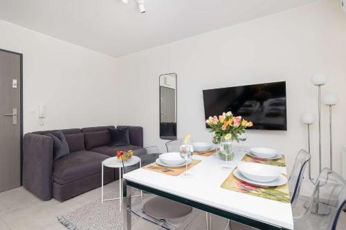 un salon avec un canapé et une table dans l'établissement Bright Studio with Terrace and Parking Close to the Sea in Niechorze by Noclegi Renters, à Niechorze