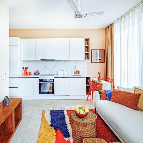 a living room with a couch and a kitchen at The Edge in Bijilo