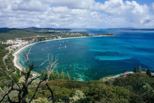 an aerial view of a beach and the ocean at Paradise at The Bay in Nelson Bay