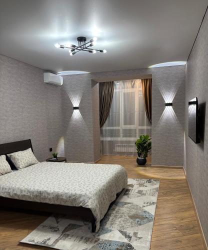 a bedroom with a bed and a ceiling fan at VIP кв 10 мкр in Oral