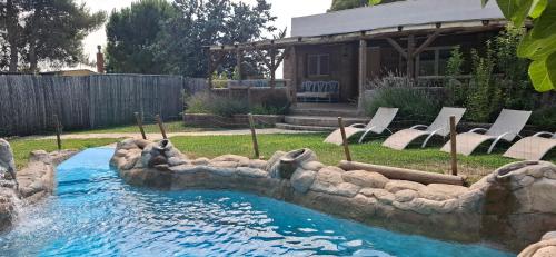 a pool in a backyard with a water slide at Casa Mirlo in Montmesa