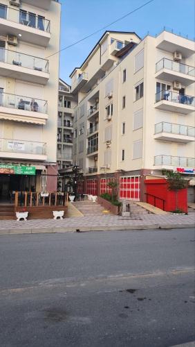an empty street in front of a large building at Studio holidays in Shëngjin