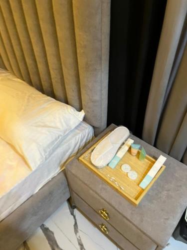 a tray with medicines on a table next to a bed at ASNB Residences Apartment 2BHK F4 in Multan