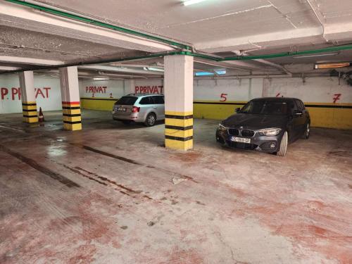 two cars are parked in a parking garage at Studio holidays in Shëngjin