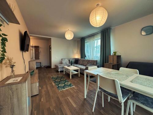 a living room with a table and a couch at Feels Like Home - free parking - powered by NEO in Timişoara