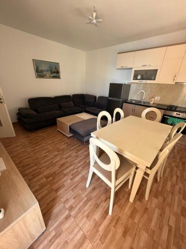 a living room with a table and a couch at Studio holidays in Shëngjin