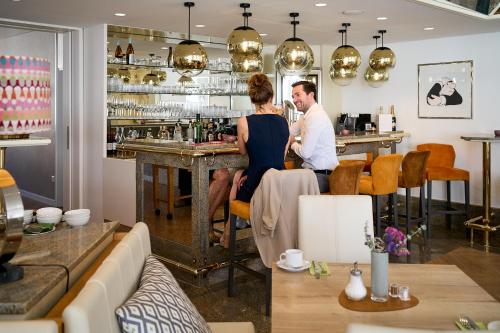 a man and a woman standing at a bar at Hotel Engbert in Oelde