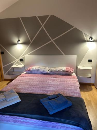 a bedroom with a large bed with two towels on it at La La Home in Avezzano