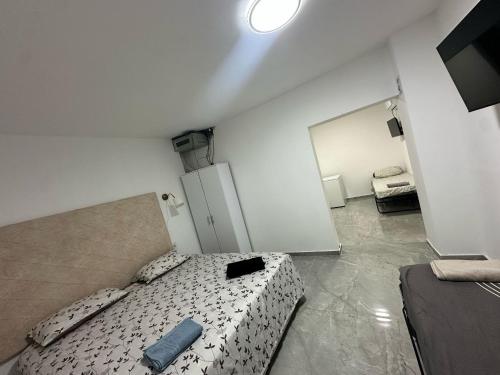 a small bedroom with a bed and a mirror at הרמוני סוויט harmony suite in Neve Zohar