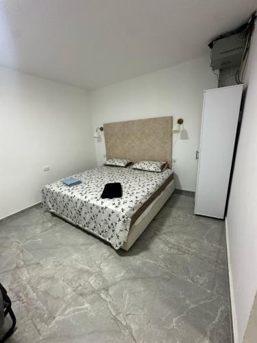 a bedroom with a bed and two white doors at הרמוני סוויט harmony suite in Neve Zohar