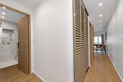 a hallway with a wall of wooden shutters in a house at FELIX FAURE - Somptueux 3 pièces - Carré d'Or Menton - PARKING in Menton