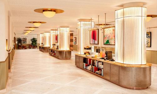 a lobby of a hotel with long counters at The Site Hotel Ibiza New Opening 2026 in Playa d'en Bossa