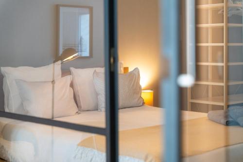 a bedroom with a bed with white pillows at Ostend Central Residence in Ostend
