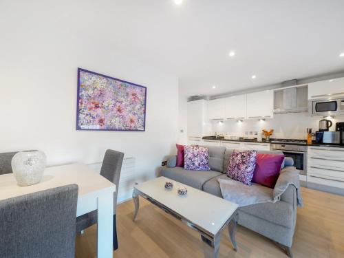 a living room with a couch and a table at Pass the Keys Bright and cozy apartment in Kentish Town in London
