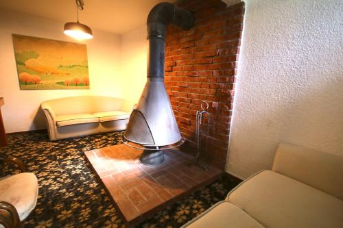 a brick wall with a stove in a room at Maple House in Myoko
