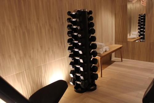 a bunch of wine bottles in a wine rack at Hôtel Amoi Paris in Paris