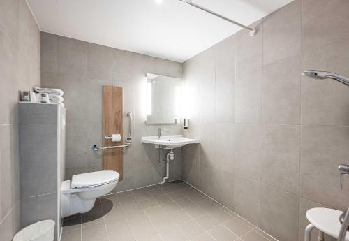 a bathroom with a toilet and a sink at B&B HOTEL Annemasse Est in Annemasse