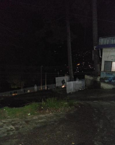 a night time view of a fence and a building at Nabeel Hotel in Dargai
