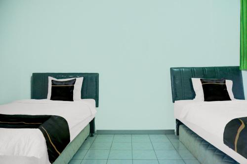 Postel nebo postele na pokoji v ubytování Dancenter Wisma Pmi