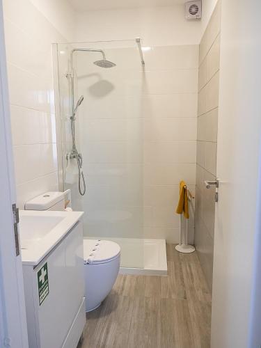 a bathroom with a shower and a toilet and a sink at Traditional Madeira House Garden, Terrace & BBQ in Ribeira Brava