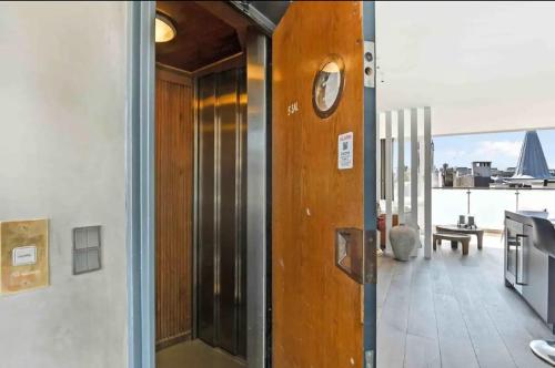a clock on the door of a room with a balcony at Elite Penthouse prime location in Copenhagen