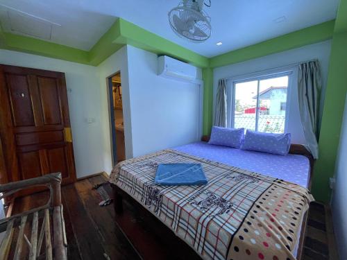 a bedroom with a bed in a room with a window at Villa Koh Rong in Koh Rong Island