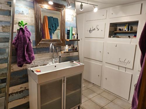 a bathroom with a sink and a mirror at Ferienhaus Wagner in Bad Königshofen im Grabfeld