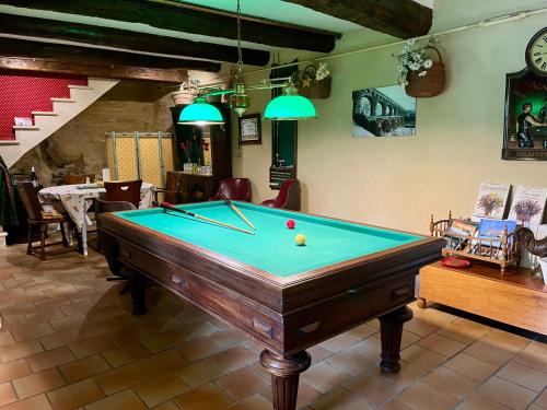 a pool table in a living room with at locastillon in Castillon-du-Gard