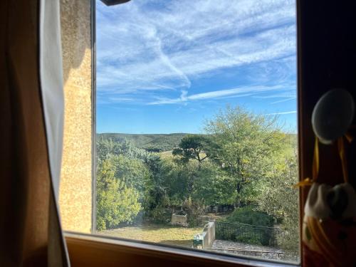 a window with a view of a mountain view at locastillon in Castillon-du-Gard